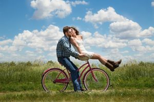 a loving couple on a bicycle