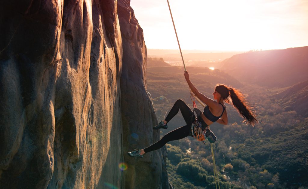 a girl climbing a mountain being spontaneous